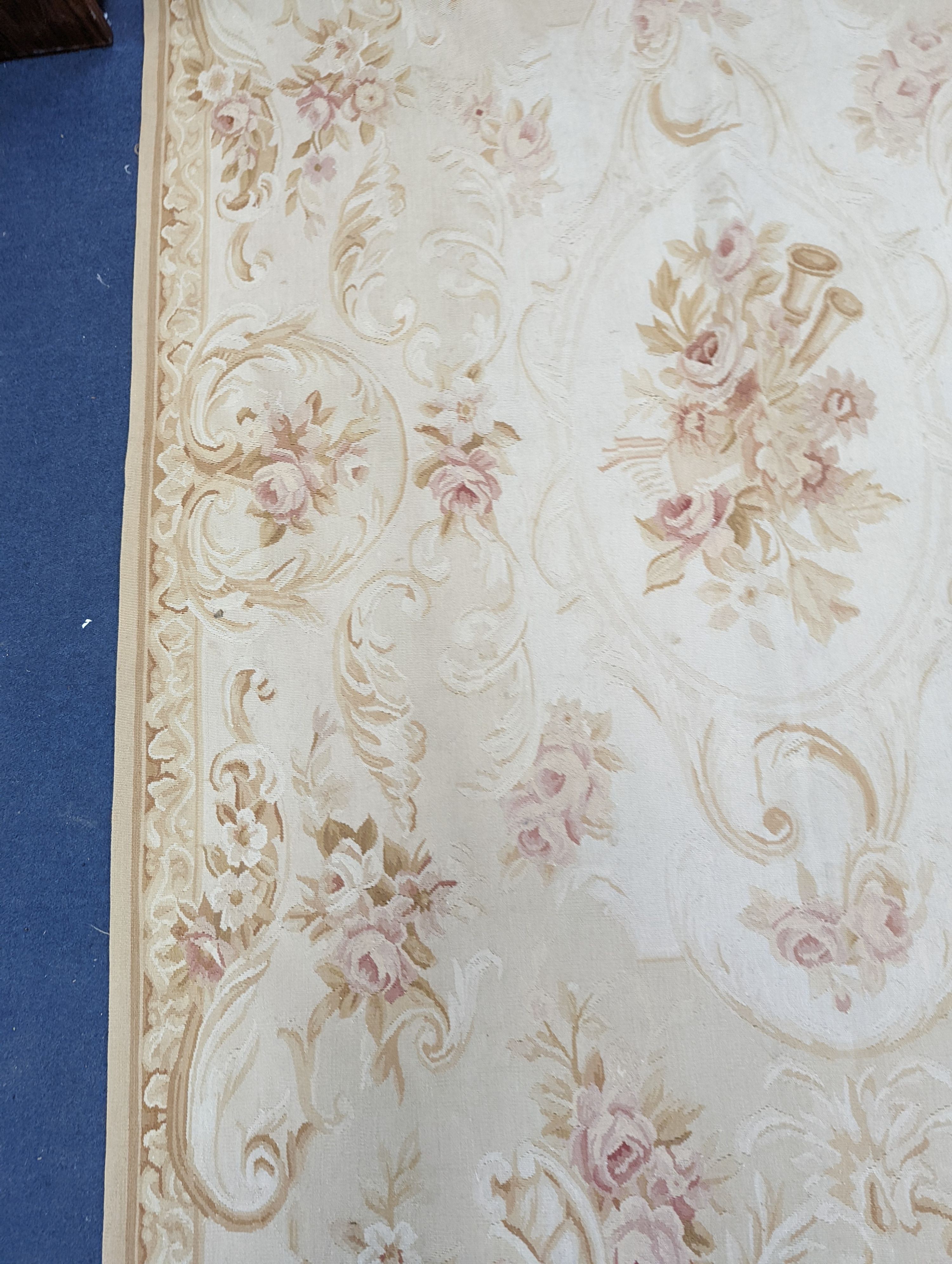 An Aubusson gold ground rug with rose pattern, 244 x 153cm